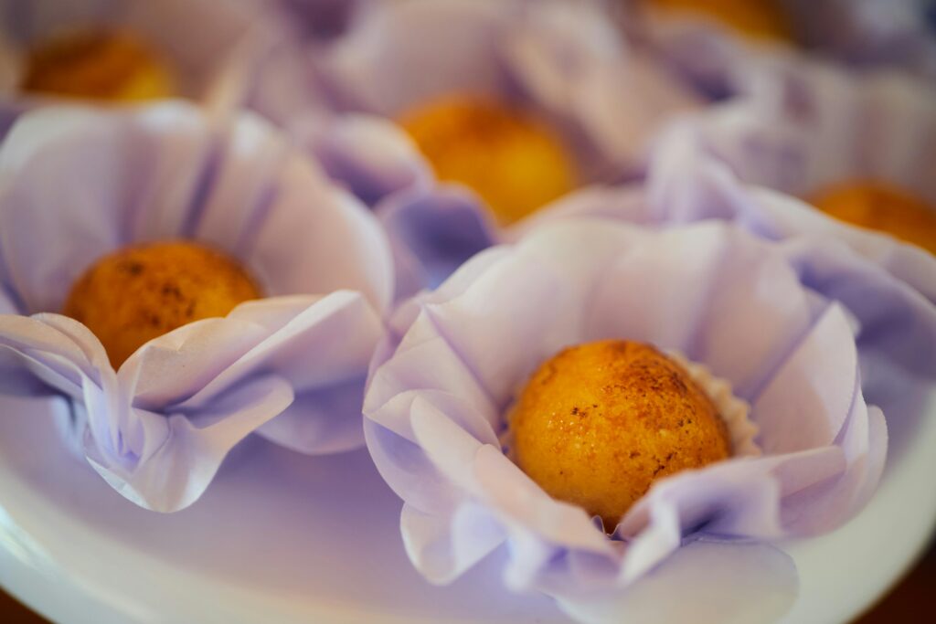 Delicious brigadeiros presented in delicate purple paper liners, ideal for festive occasions.